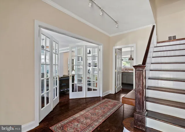 a view of entryway livingroom and hall with wooden floor