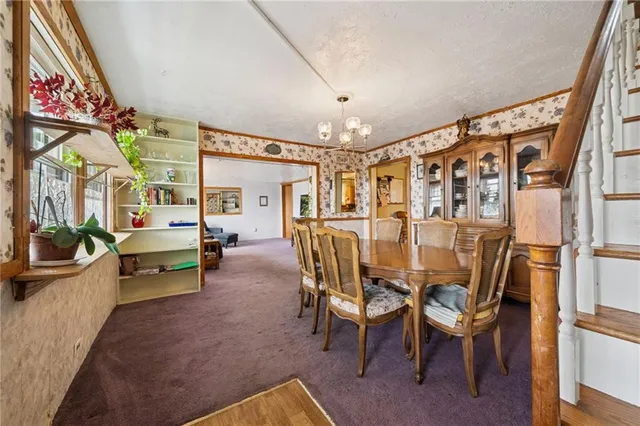 a dining room with furniture and large windows