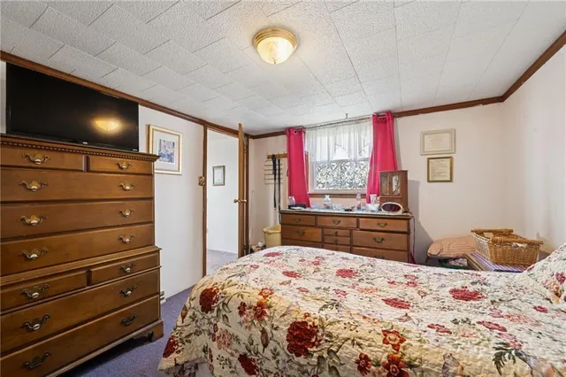 a bedroom with a bed and flat screen tv