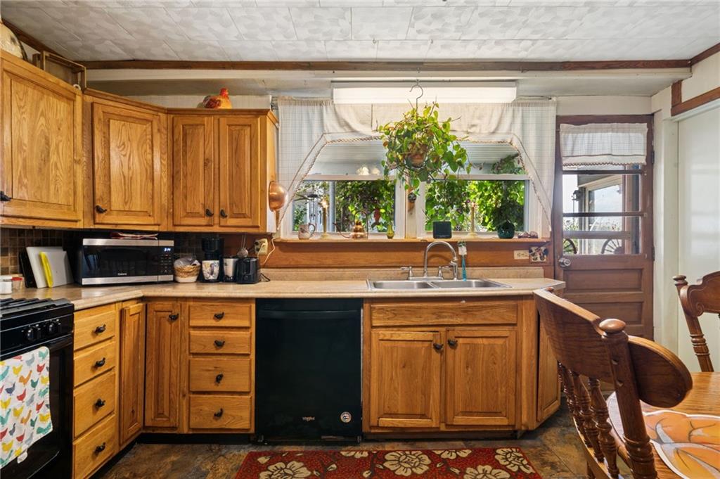 115 Truxall Road Apollo, PA 15613 - Photo 26 of 39 a kitchen with stainless steel appliances granite countertop a sink stove and cabinets