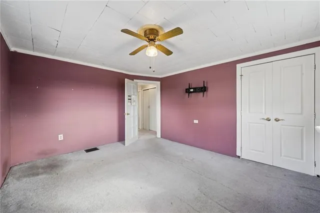 a view of a livingroom with a ceiling fan and window