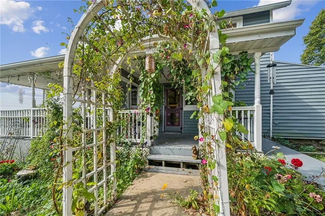 a view of a pathway of a house with potted plants