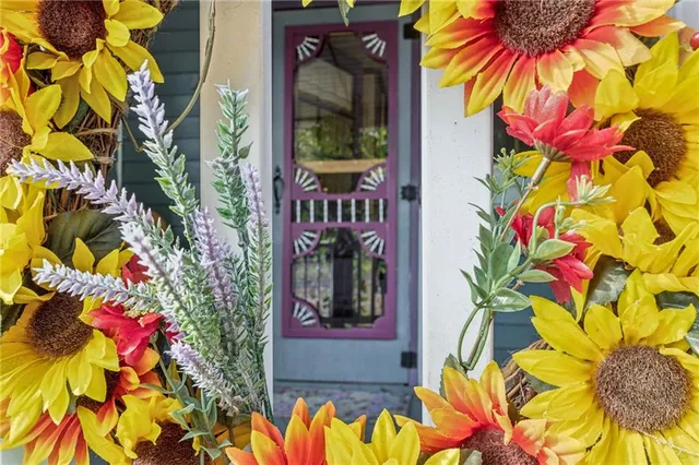 a vase of flowers sitting in front of a door