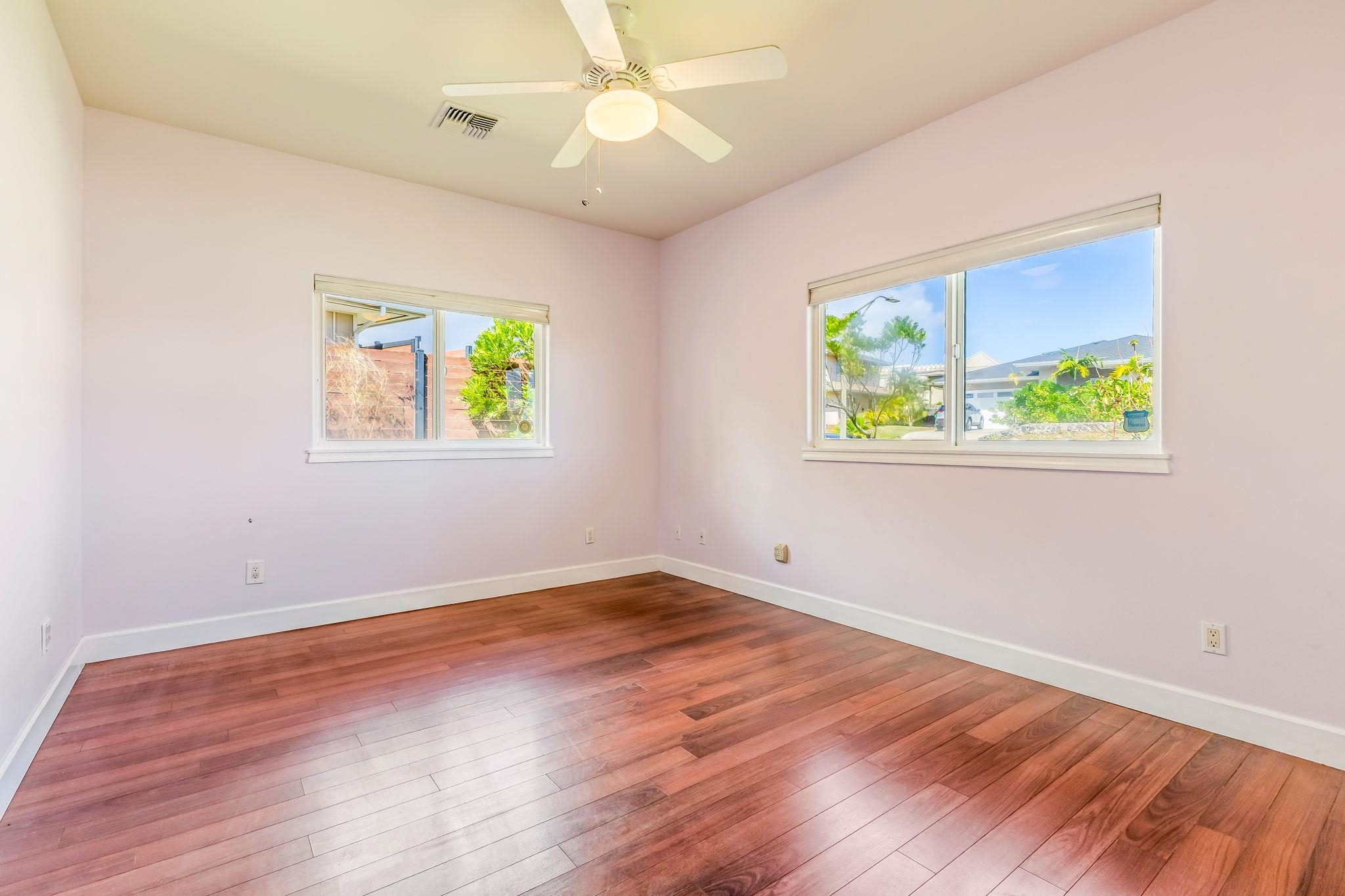 33 Keoneloa Street Wailuku, HI 96793 - Photo 31 of 40 an empty room with wooden floor ceiling fan and windows