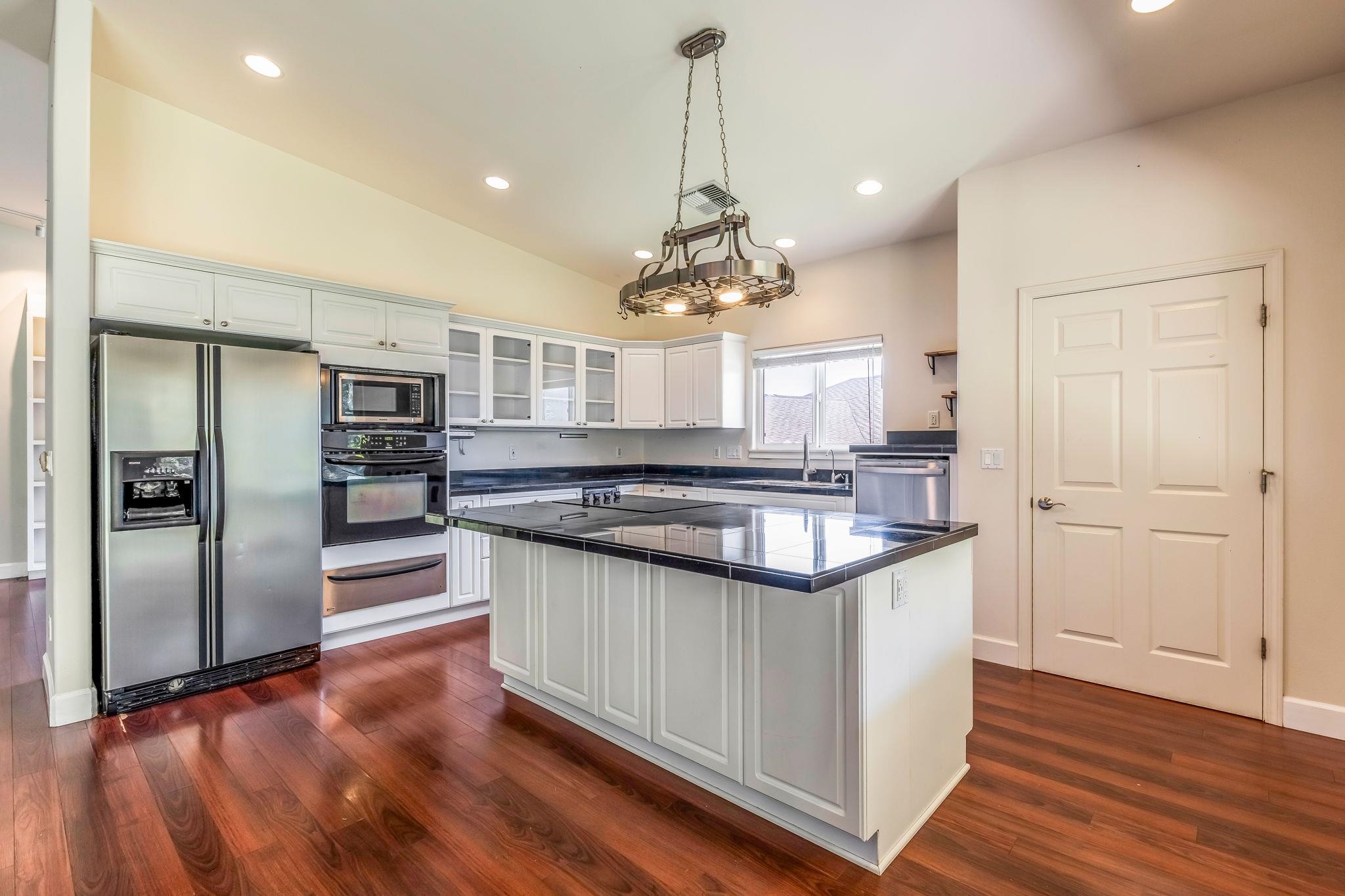 33 Keoneloa Street Wailuku, HI 96793 - Photo 5 of 40 a kitchen with stainless steel appliances granite countertop a sink and a refrigerator