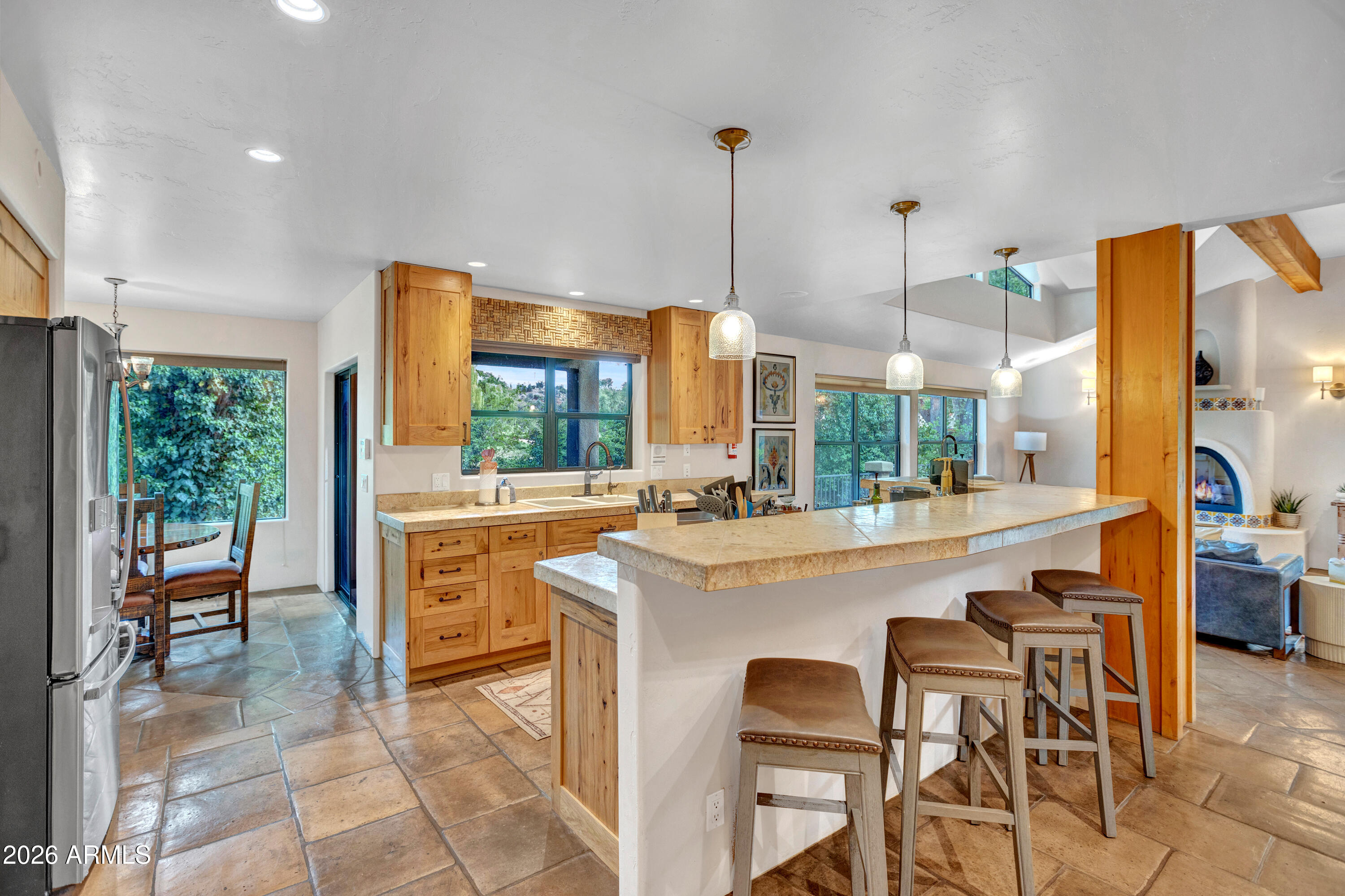 55 Ranch House Circle Sedona, AZ 86336 - Photo 6 of 61 a kitchen with stainless steel appliances kitchen island granite countertop a table and chairs