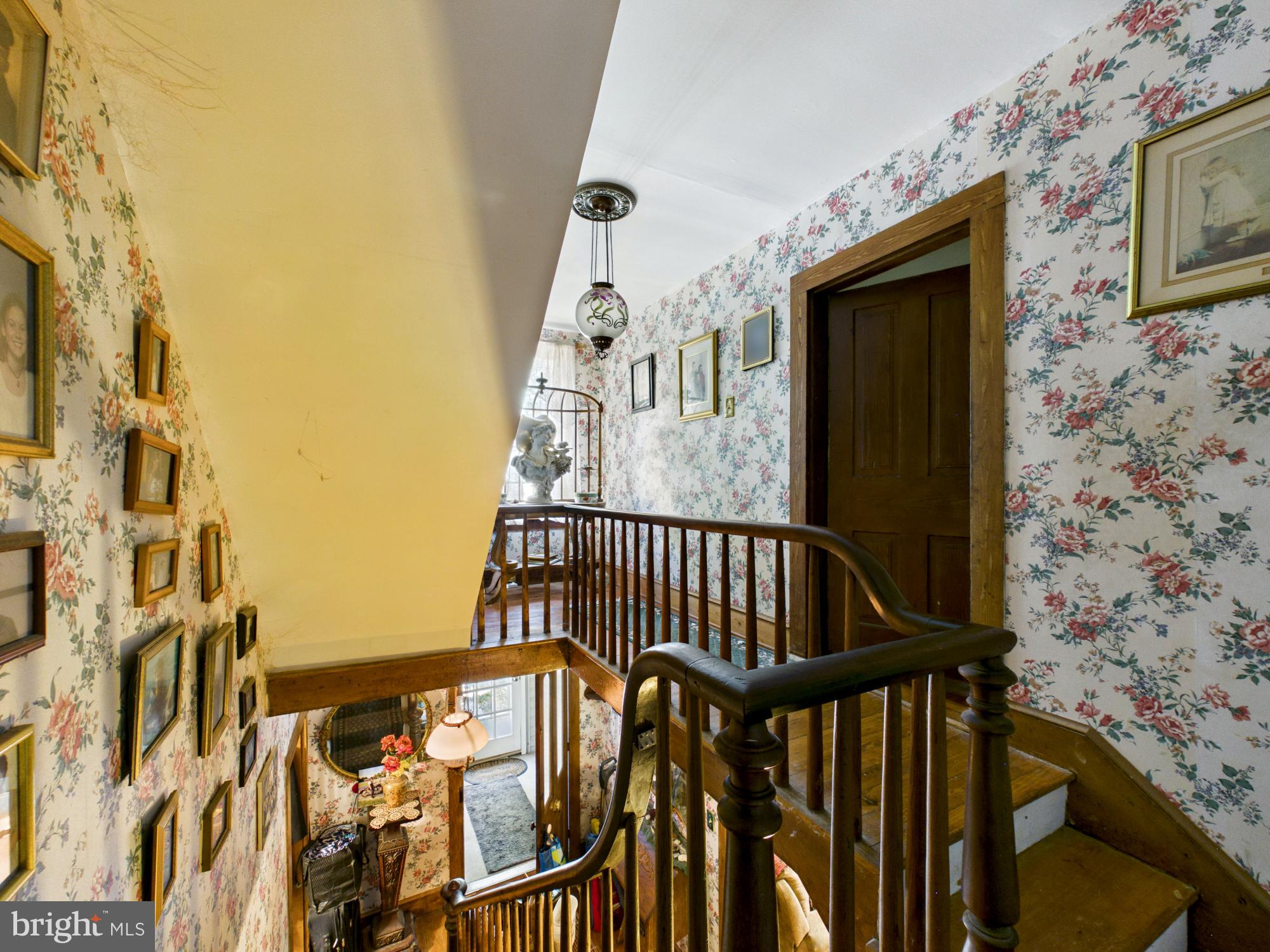 20488 Nanticoke Road Nanticoke, MD 21840 - Photo 21 of 32 Charming staircase in floral embrace.