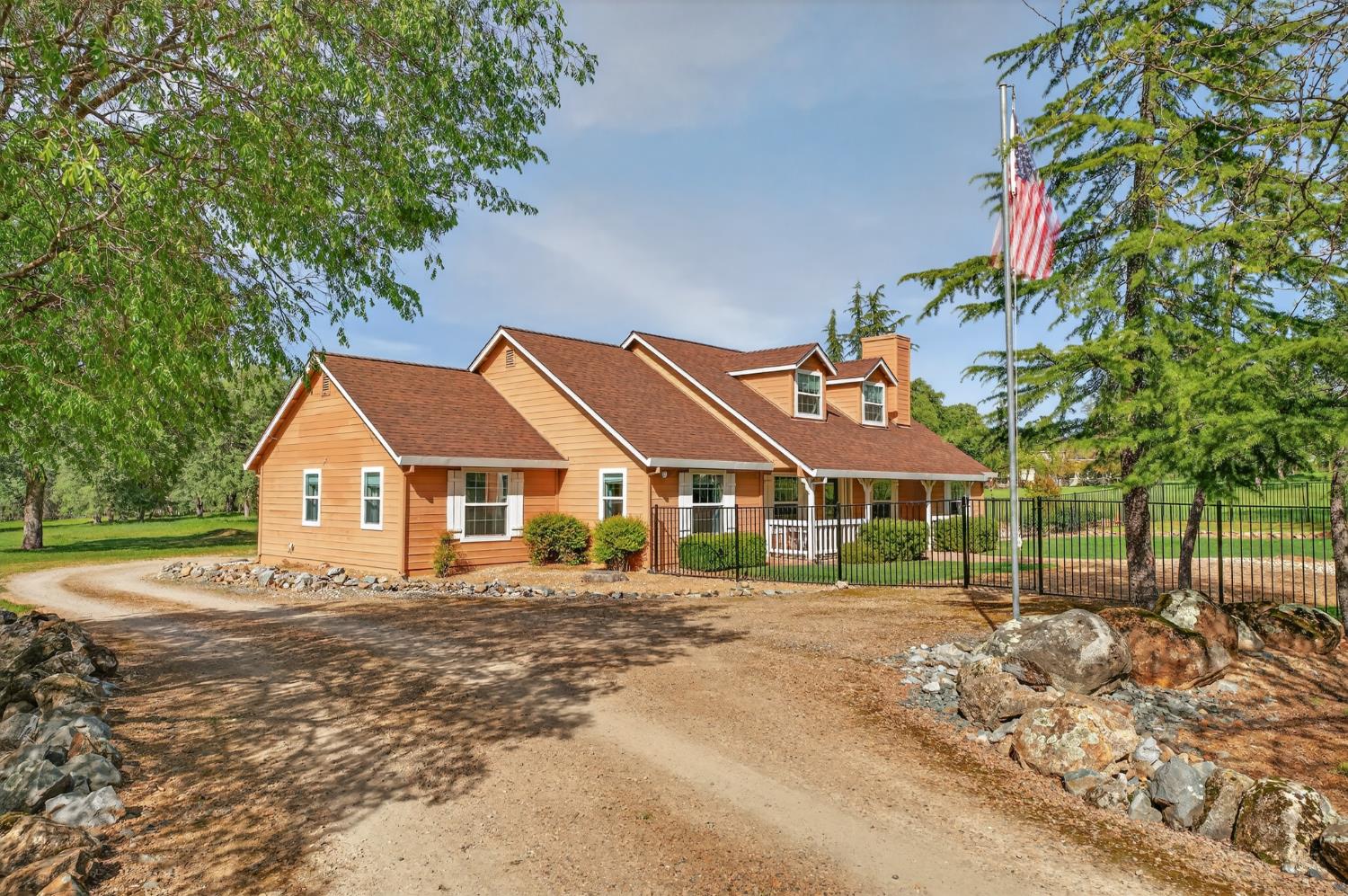 26583 Table Meadow Road Auburn, CA 95602 - Photo 13 of 77 a front view of a house with a yard and trees
