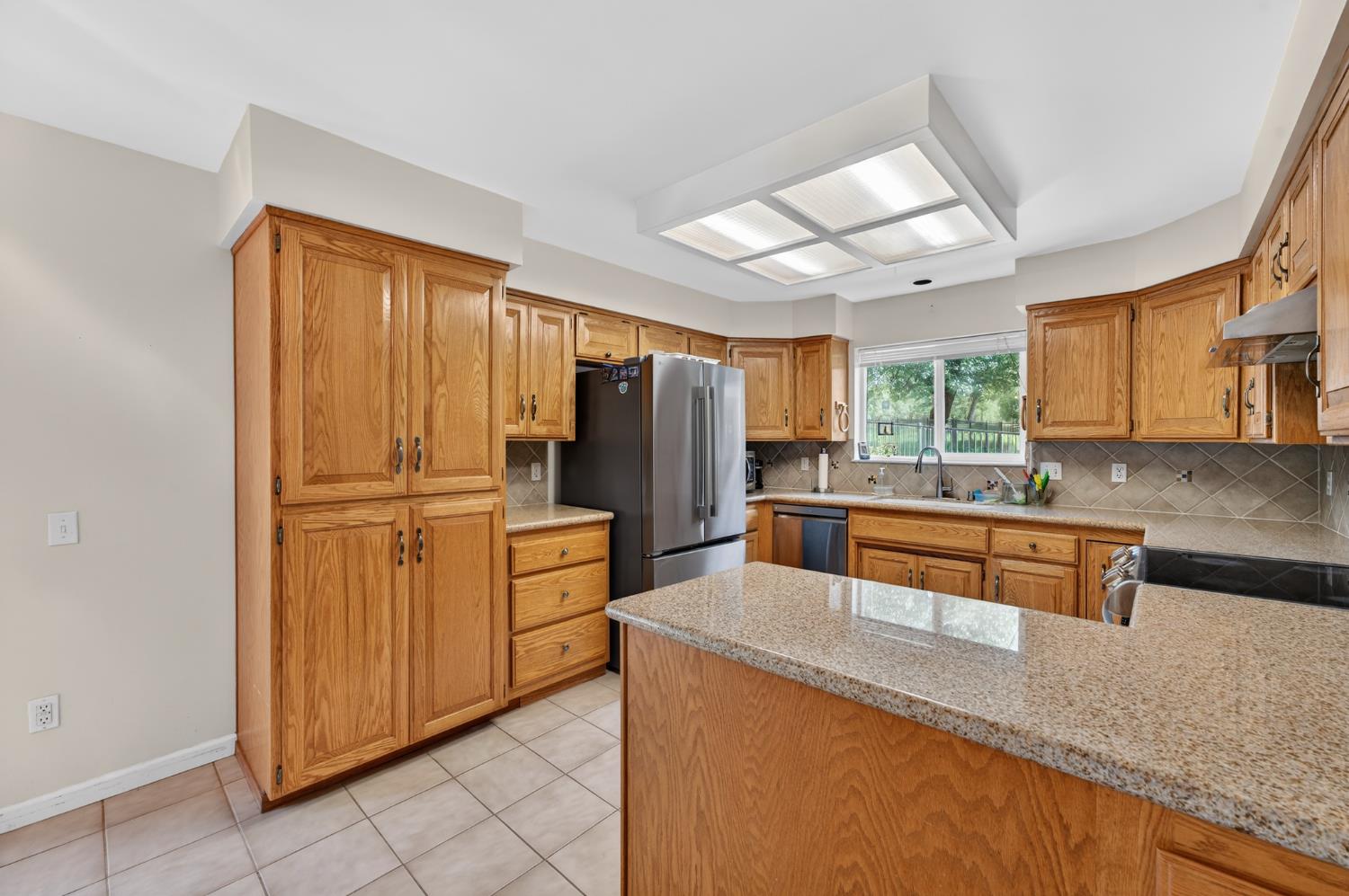 26583 Table Meadow Road Auburn, CA 95602 - Photo 23 of 77 a kitchen with stainless steel appliances granite countertop a refrigerator and a stove top oven