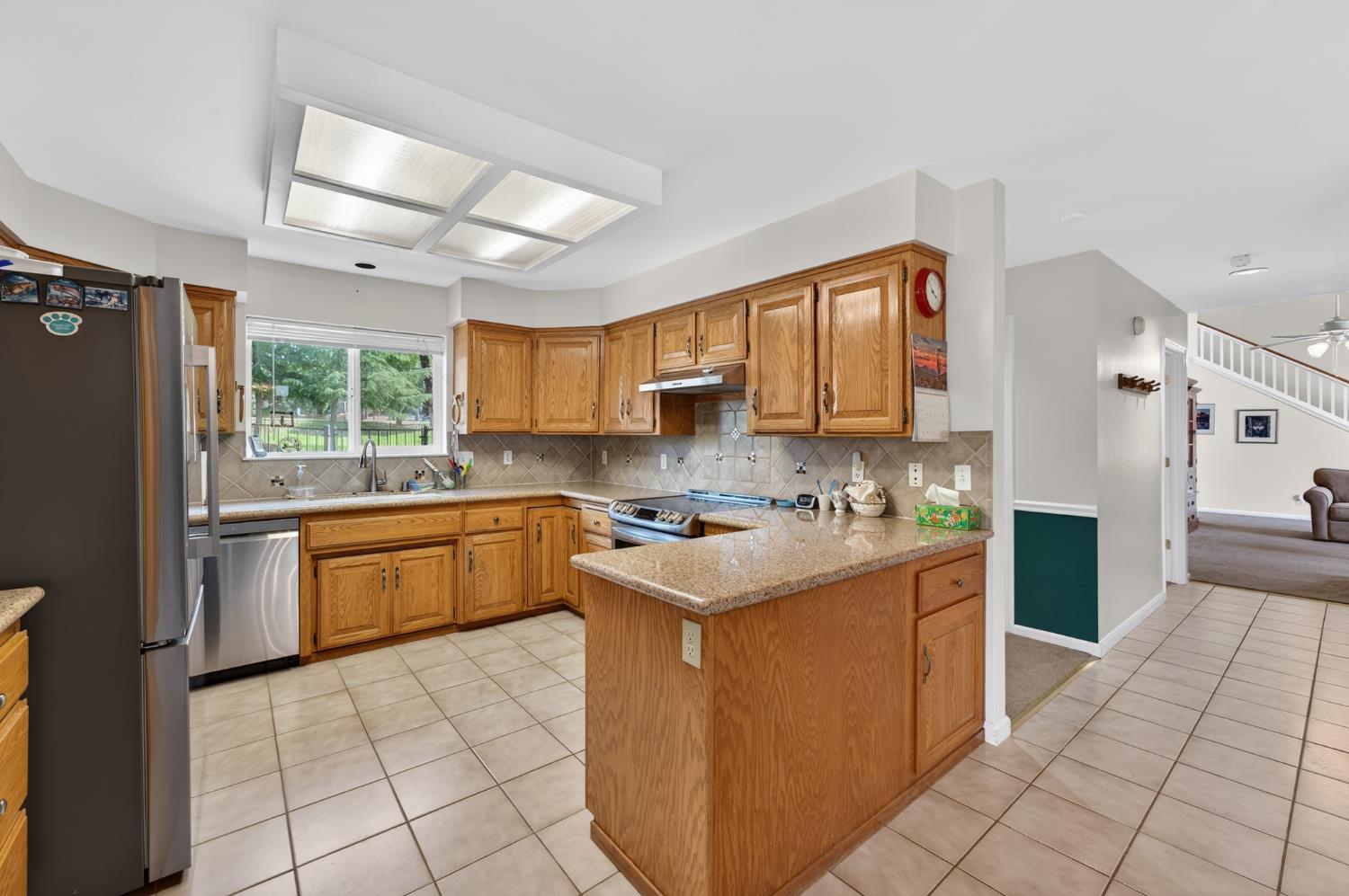 26583 Table Meadow Road Auburn, CA 95602 - Photo 25 of 77 a kitchen with stainless steel appliances granite countertop a stove a sink dishwasher and a refrigerator