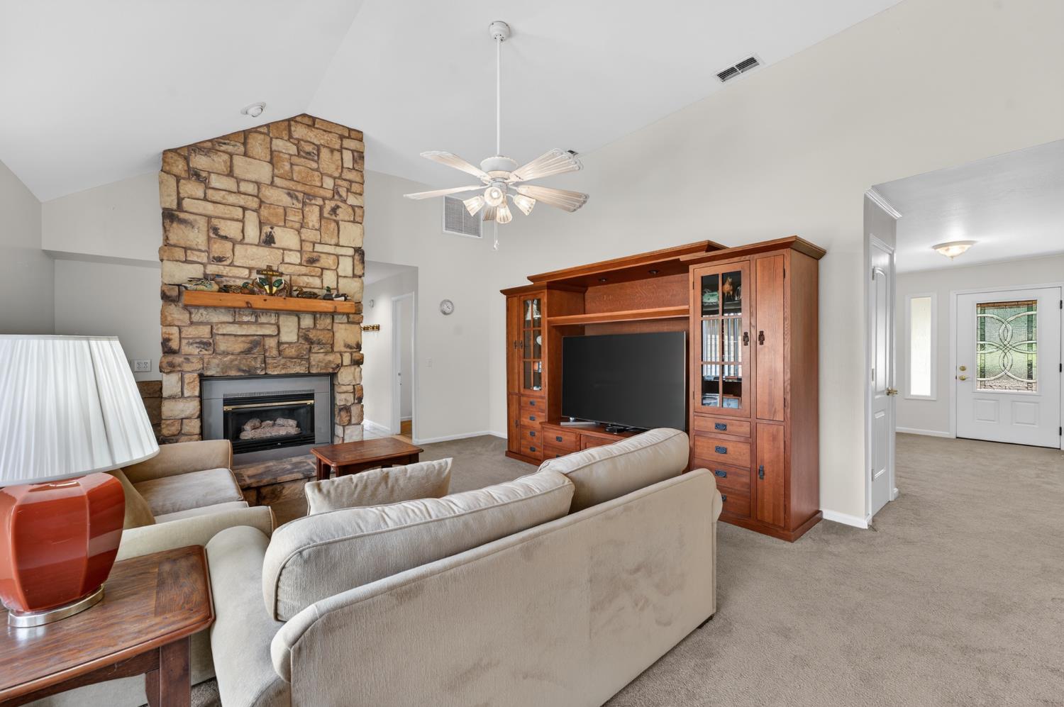 26583 Table Meadow Road Auburn, CA 95602 - Photo 31 of 77 a living room with furniture a fireplace and a flat screen tv