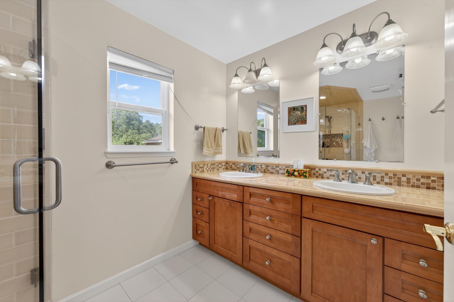 26583 Table Meadow Road Auburn, CA 95602 - Photo 41 of 77 a bathroom with a granite countertop sink a mirror and a shower
