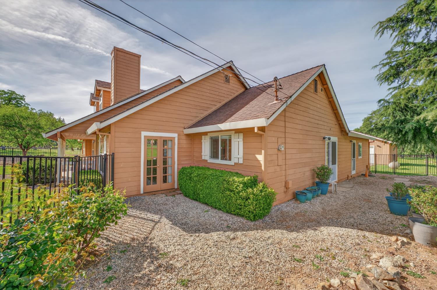 26583 Table Meadow Road Auburn, CA 95602 - Photo 50 of 77 a front view of a house with a yard and potted plants