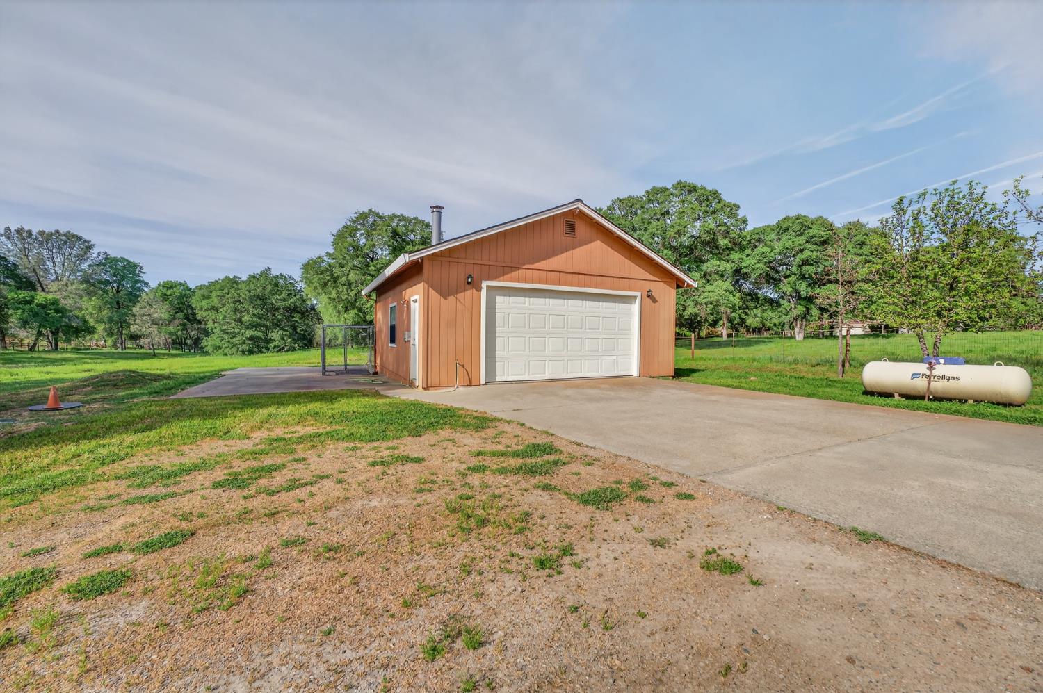 26583 Table Meadow Road Auburn, CA 95602 - Photo 58 of 77 a front view of a house with a yard and garage