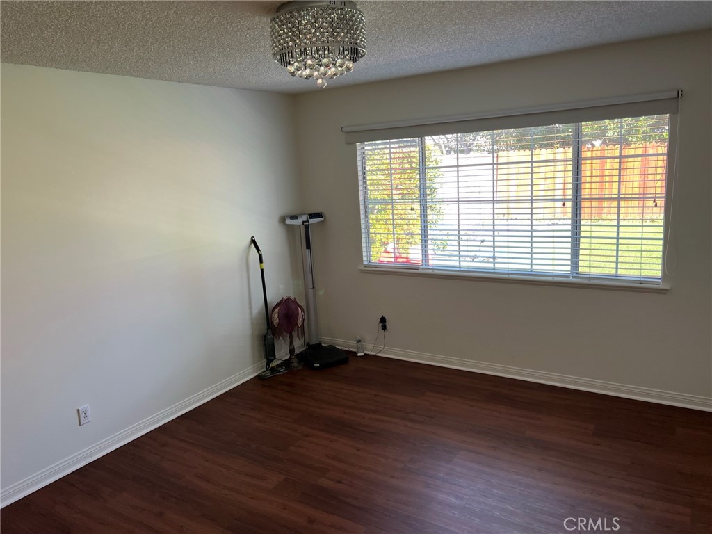 2256 Rutgers Drive Costa Mesa, CA 92626 - Photo 9 of 11 an empty room with wooden floor and windows