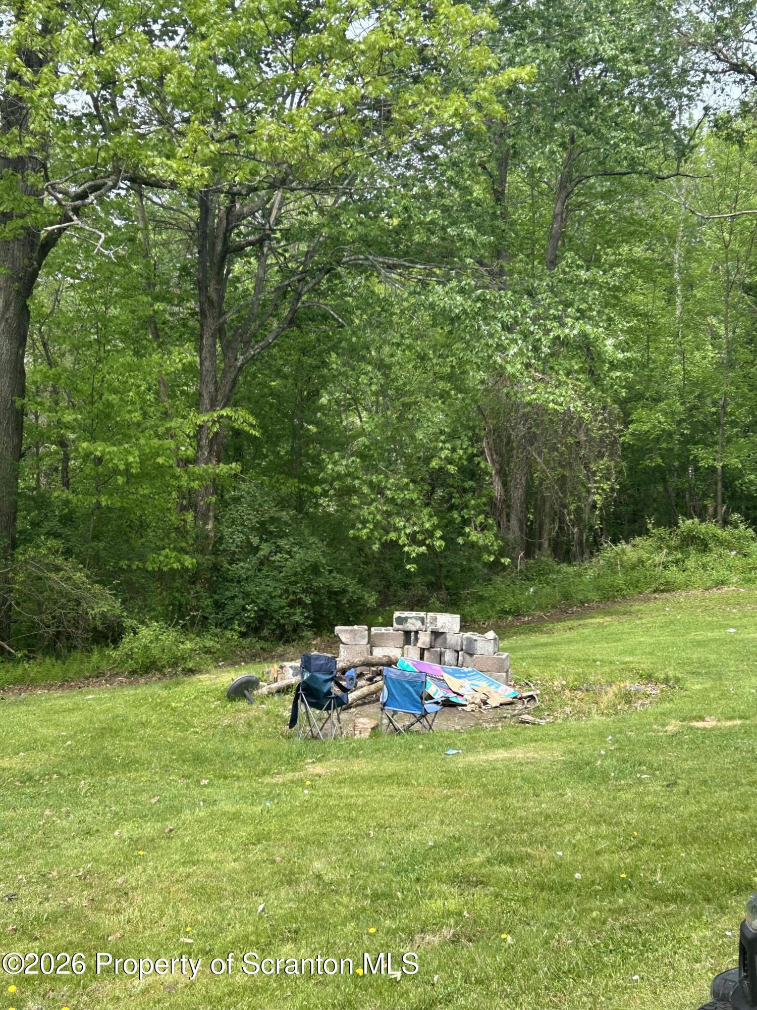 63 Shannon Street Simpson, PA 18407 - Photo 7 of 18 a backyard of a house with table and chairs