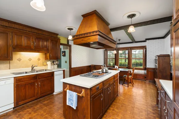 a kitchen that has a sink and a stove in it