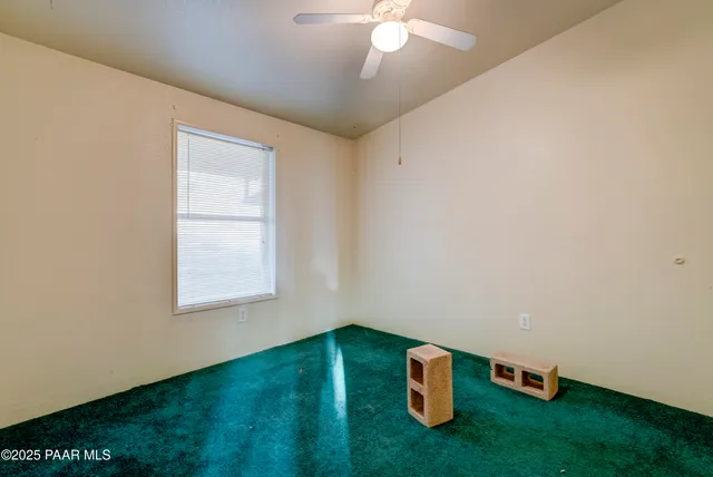 an empty room with closet and a yard