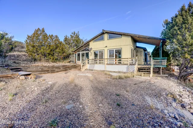 a view of an chair and table in the balcony