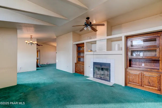 a view of a livingroom with a fireplace and cabinet