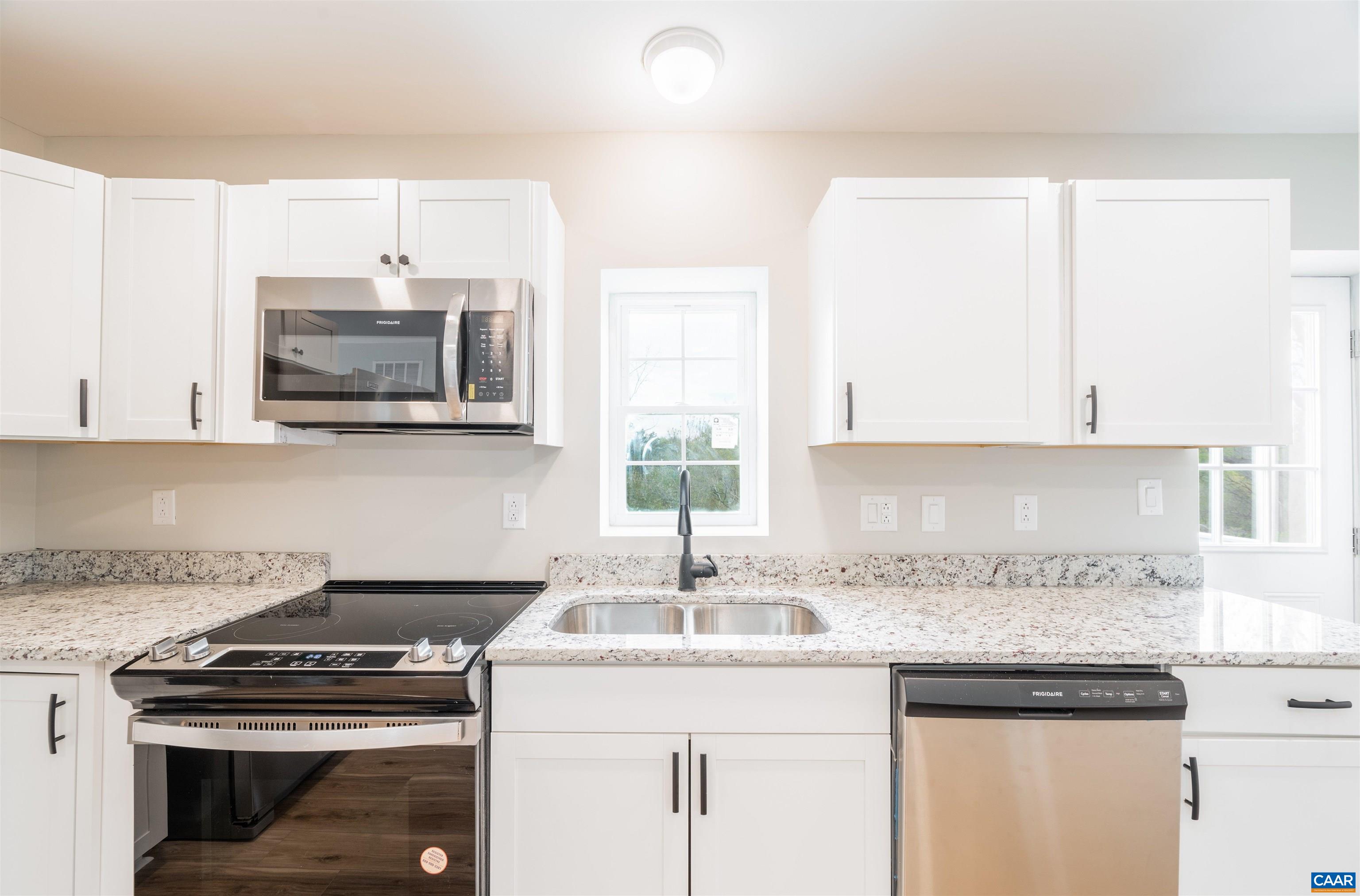 839 Ridge Street Charlottesville, VA 22902 - Photo 12 of 26 a kitchen with granite countertop a sink a stove and cabinets
