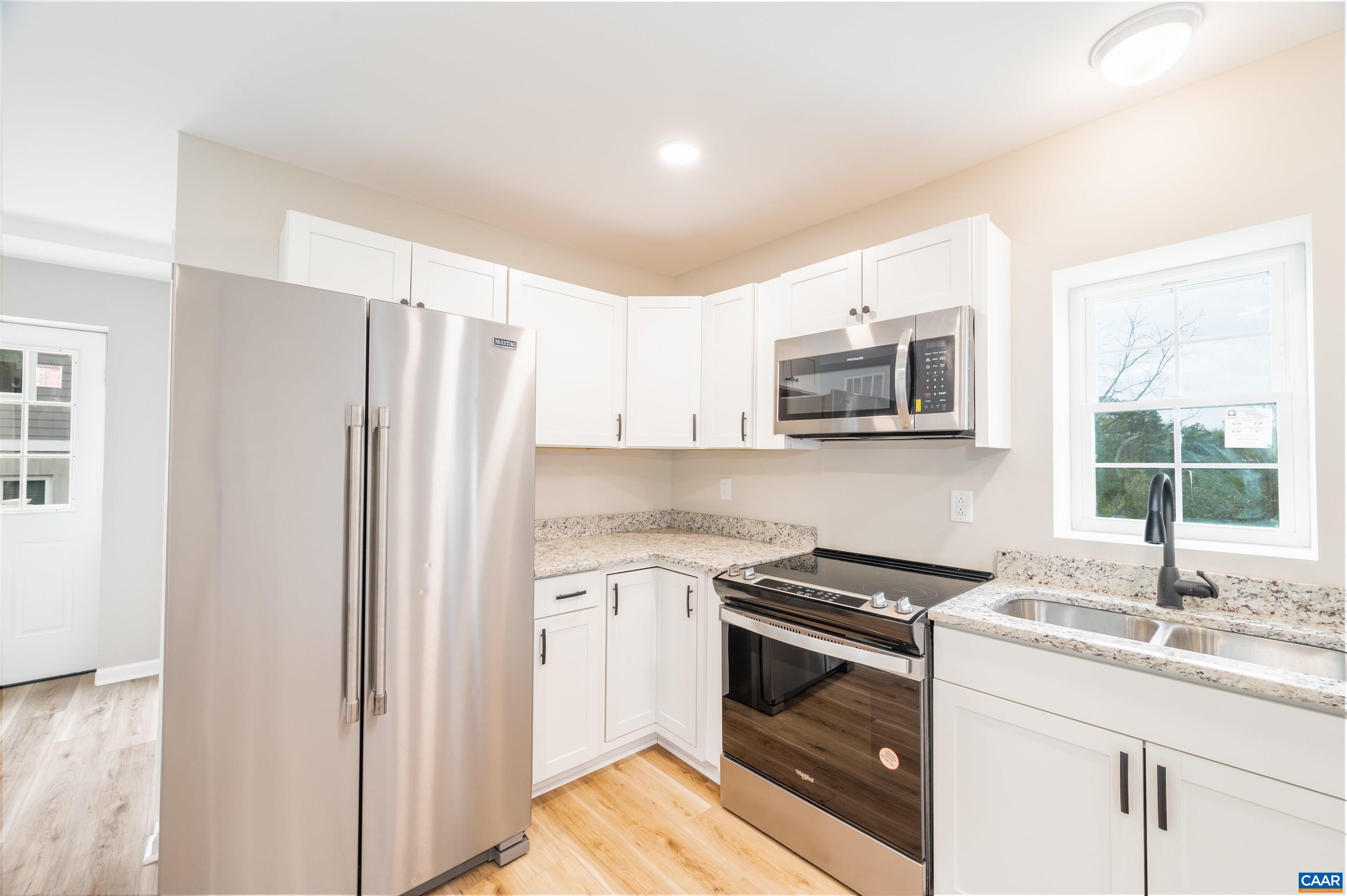 839 Ridge Street Charlottesville, VA 22902 - Photo 13 of 26 a kitchen with granite countertop a refrigerator stove and sink
