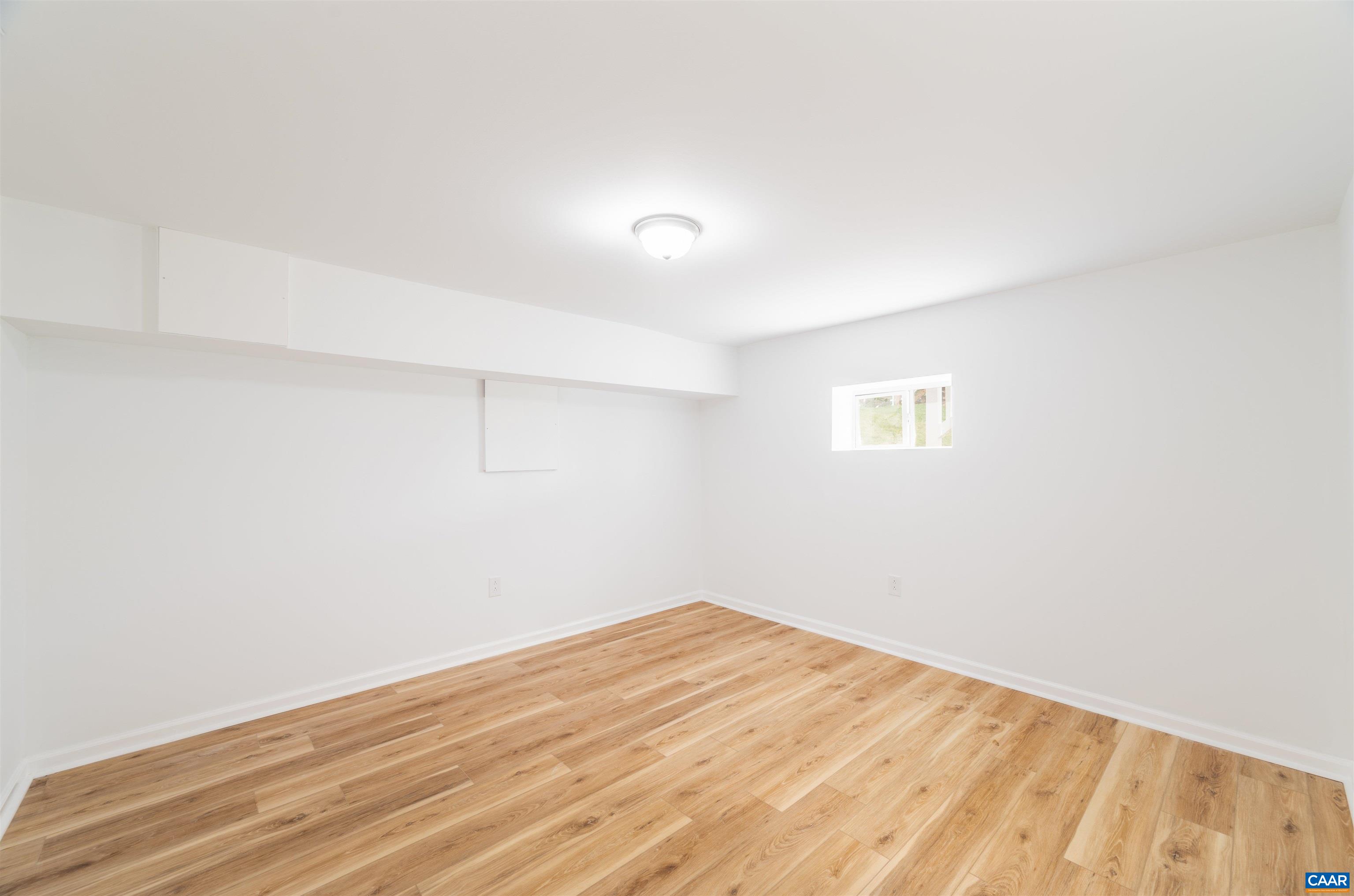 839 Ridge Street Charlottesville, VA 22902 - Photo 21 of 26 an empty room with wooden floor and windows