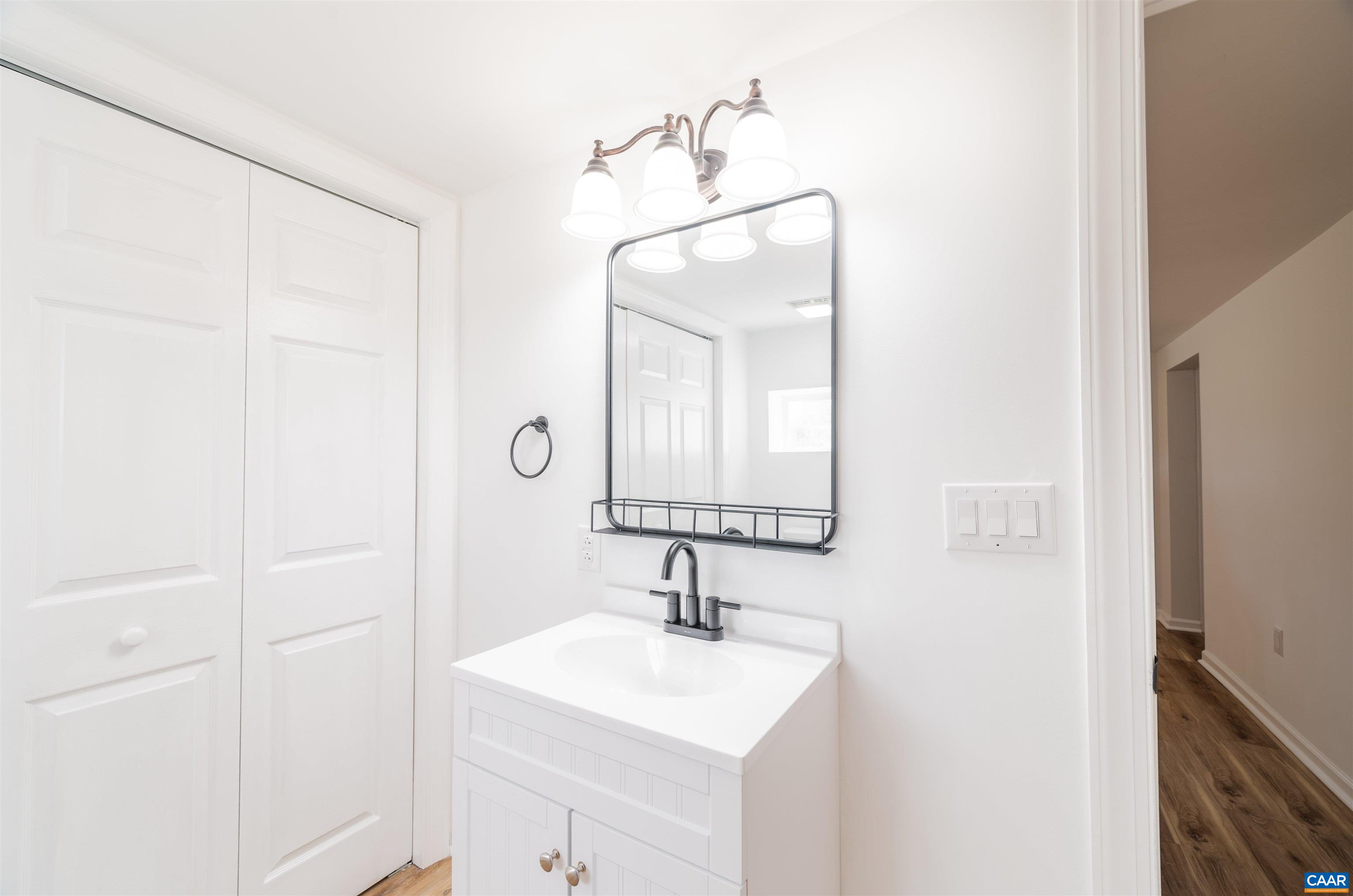 839 Ridge Street Charlottesville, VA 22902 - Photo 23 of 26 a bathroom with a sink a mirror and vanity