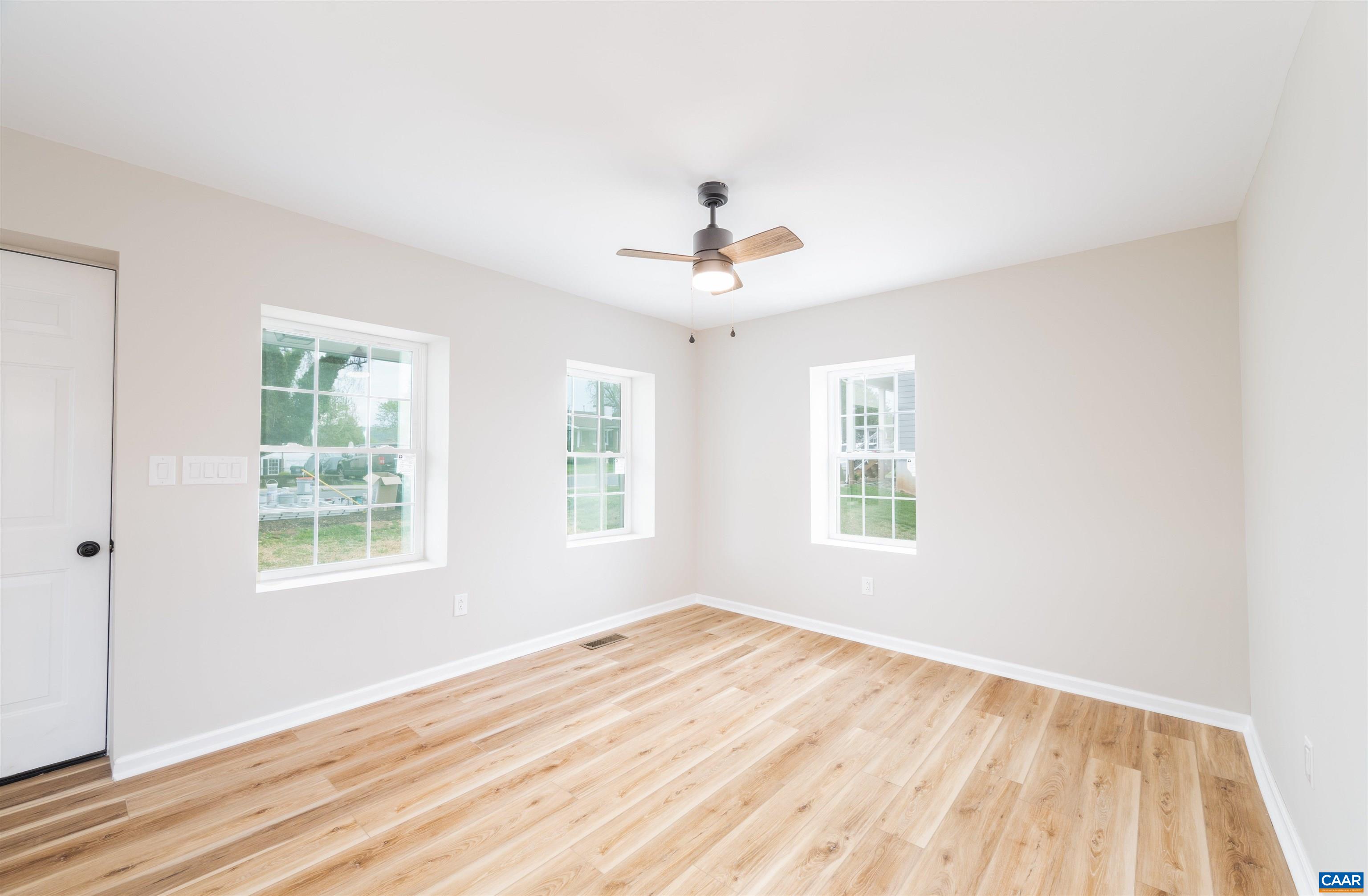 839 Ridge Street Charlottesville, VA 22902 - Photo 6 of 26 a view of an empty room with wooden floor and a window