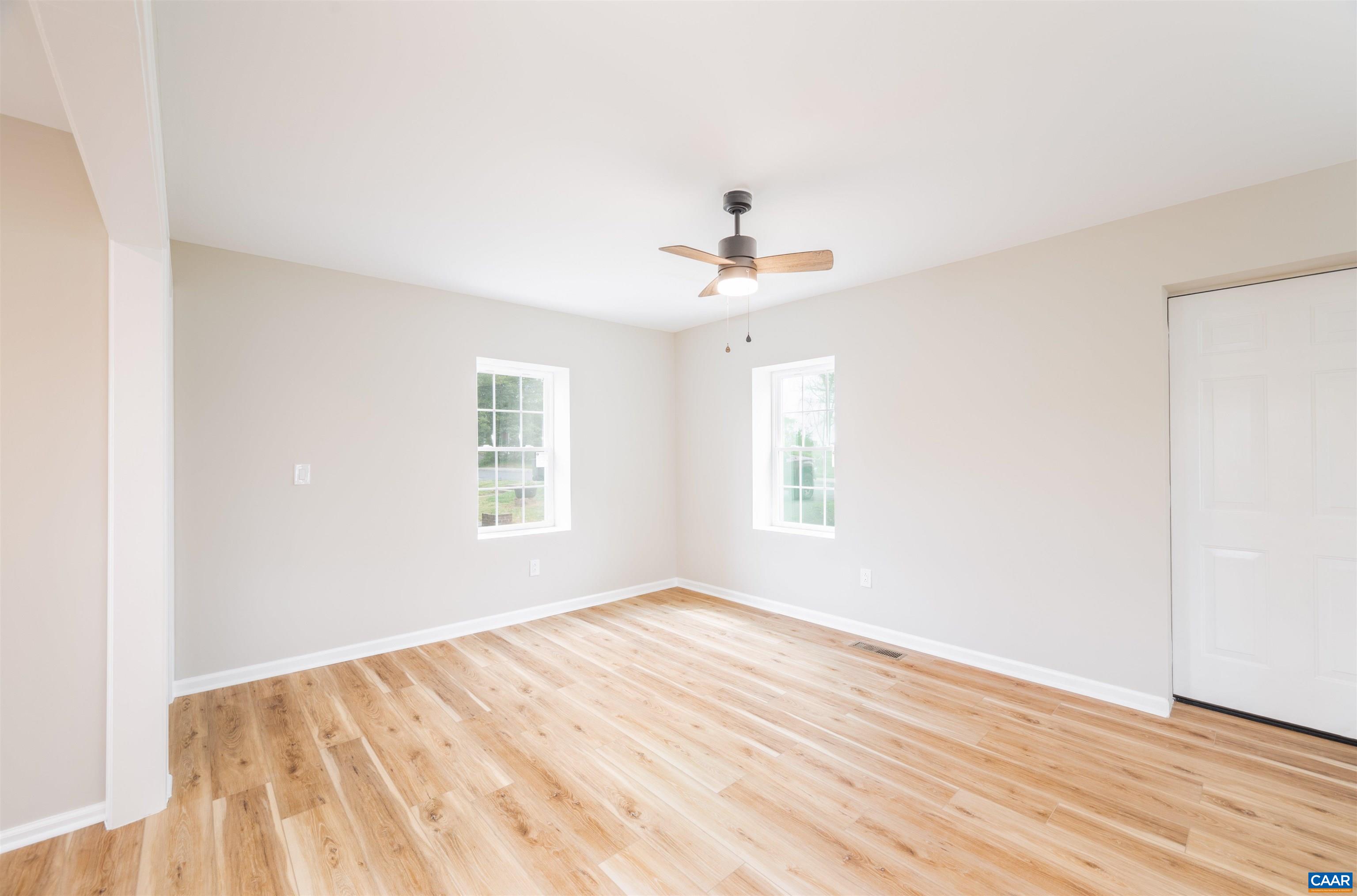 839 Ridge Street Charlottesville, VA 22902 - Photo 7 of 26 a view of an empty room with wooden floor and a window