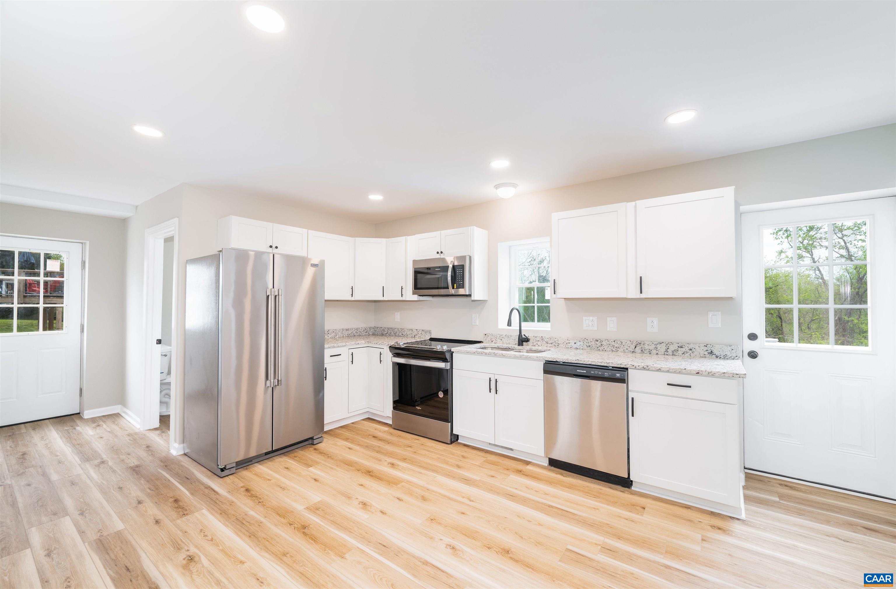 839 Ridge Street Charlottesville, VA 22902 - Photo 10 of 26 a kitchen with stainless steel appliances granite countertop a stove and a refrigerator
