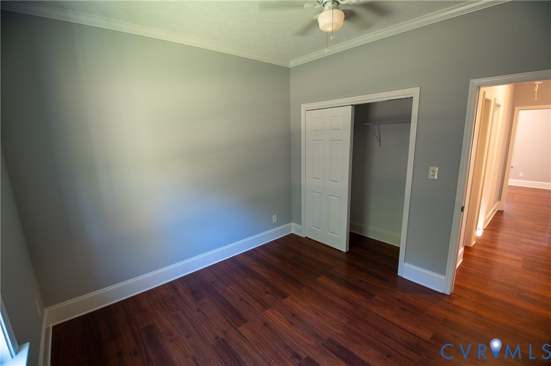 7491 Richmond Road Amelia Court House, VA 23002 - Photo 14 of 39 an empty room with wooden floor and door