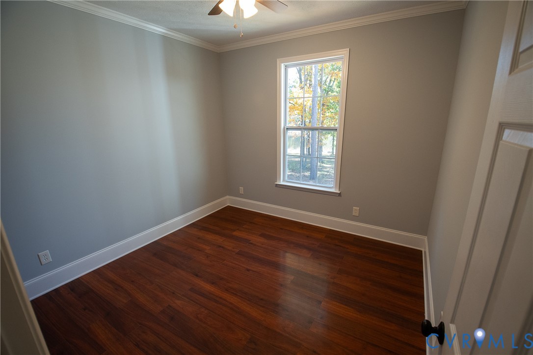 7491 Richmond Road Amelia Court House, VA 23002 - Photo 19 of 39 an empty room with wooden floor and windows