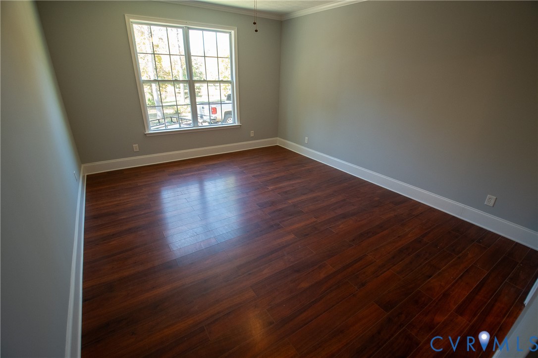7491 Richmond Road Amelia Court House, VA 23002 - Photo 21 of 39 an empty room with wooden floor and windows