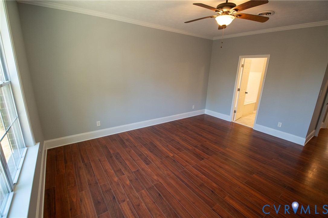 7491 Richmond Road Amelia Court House, VA 23002 - Photo 22 of 39 an empty room with wooden floor fan and windows