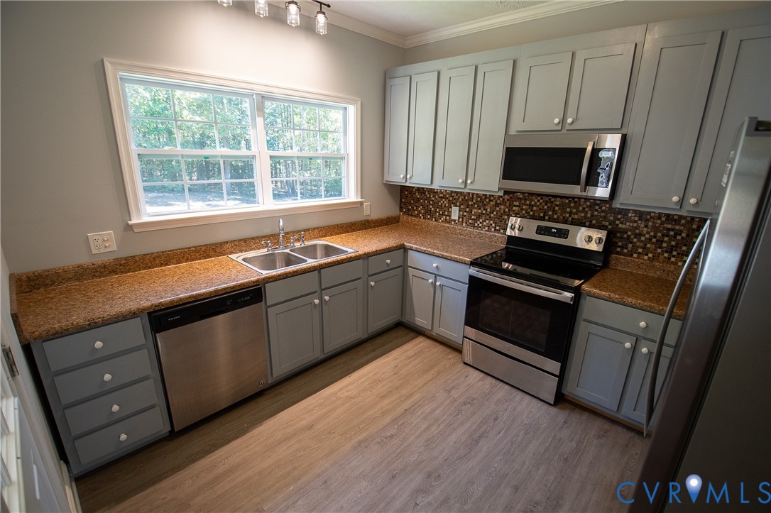 7491 Richmond Road Amelia Court House, VA 23002 - Photo 9 of 39 a kitchen with stainless steel appliances granite countertop a stove a microwave and a sink