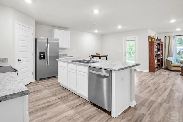 a utility room with cabinets washer and dryer