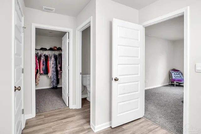 hallway view with wooden floor and closet