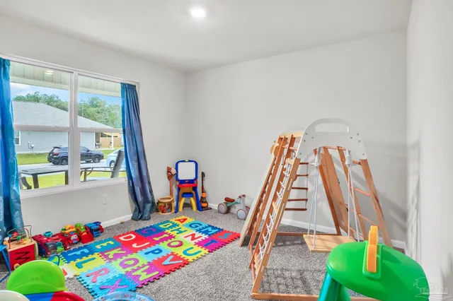 a living room with a baby crib furniture and a table
