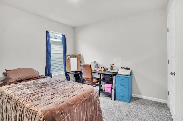 a bedroom with a bed and a desk