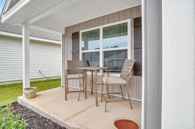 a balcony with chairs and a table