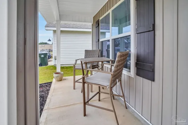 a view of two chairs in the balcony