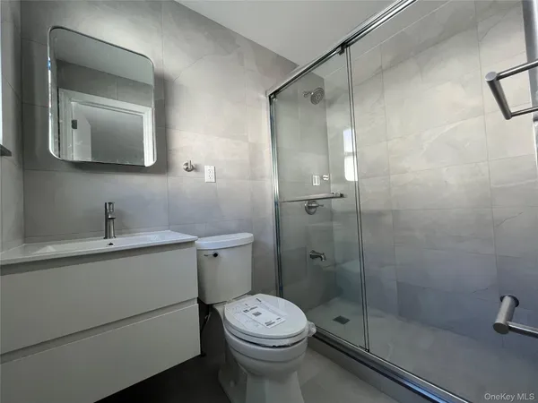 a bathroom with a toilet sink and shower