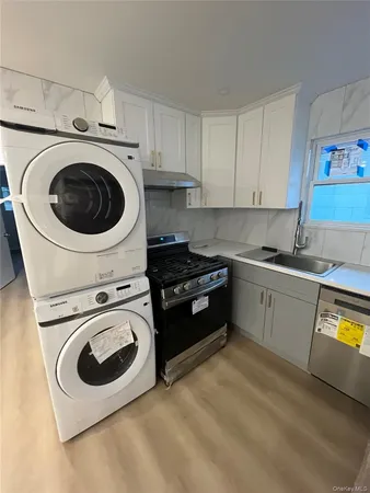 a utility room with sink dryer and washer