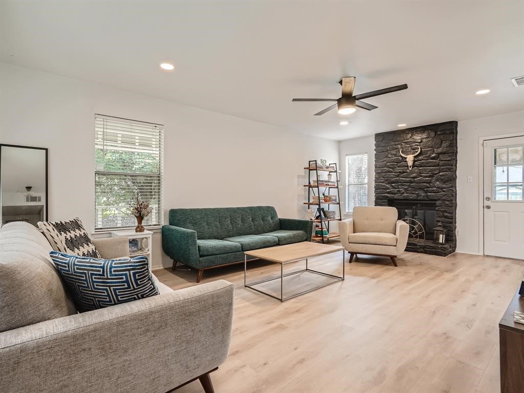 a living room with furniture and a fireplace
