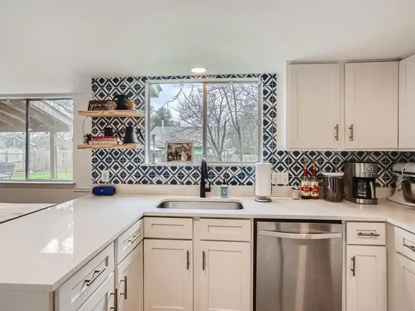 a kitchen with a sink and cabinets