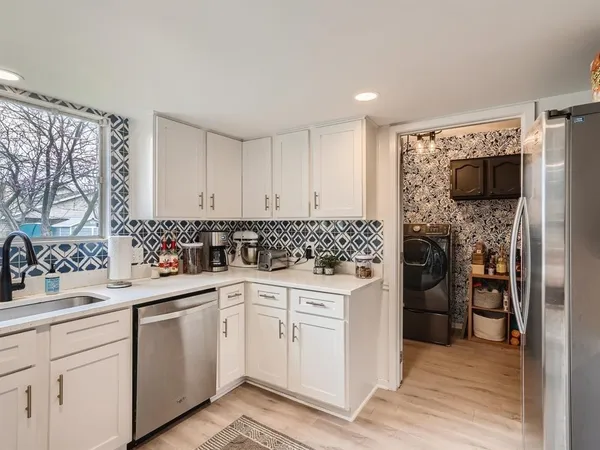 a kitchen with a sink stove and refrigerator
