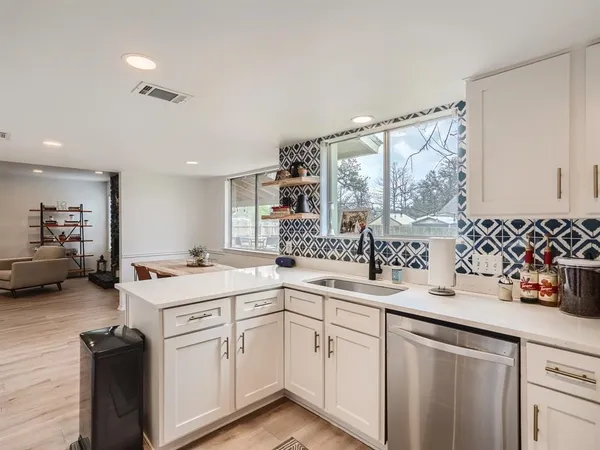 a kitchen with a sink stove and cabinets
