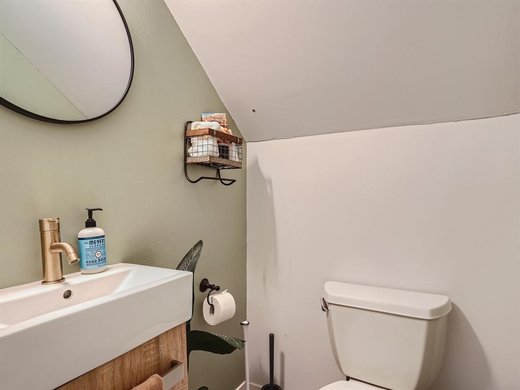 7701 Copano Drive Austin, TX 78749 - Photo 16 of 27 a bathroom with a sink a toilet and mirror