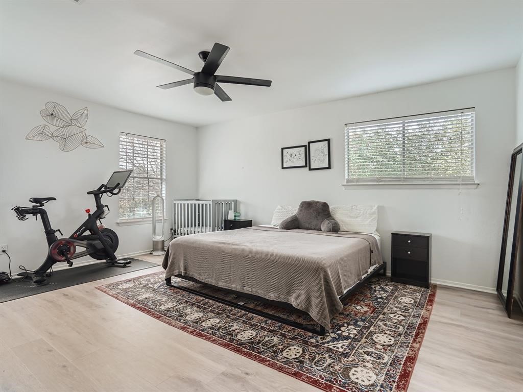 7701 Copano Drive Austin, TX 78749 - Photo 17 of 27 a bedroom with a bed and wooden floor